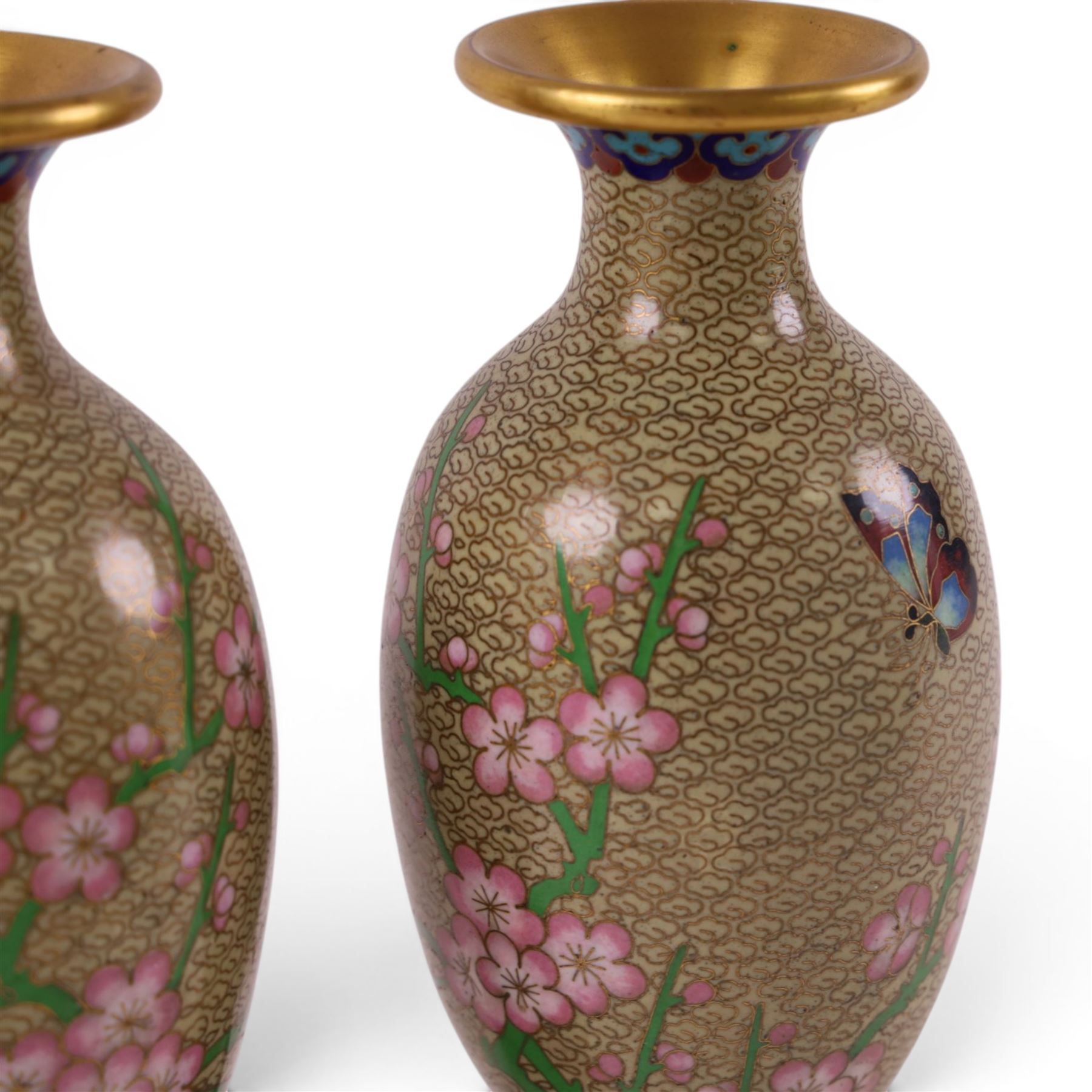 Pair of Cloisonné vases decorated with cherry blossom and peonies, upon a carved hardstone wooden base, H24cm 