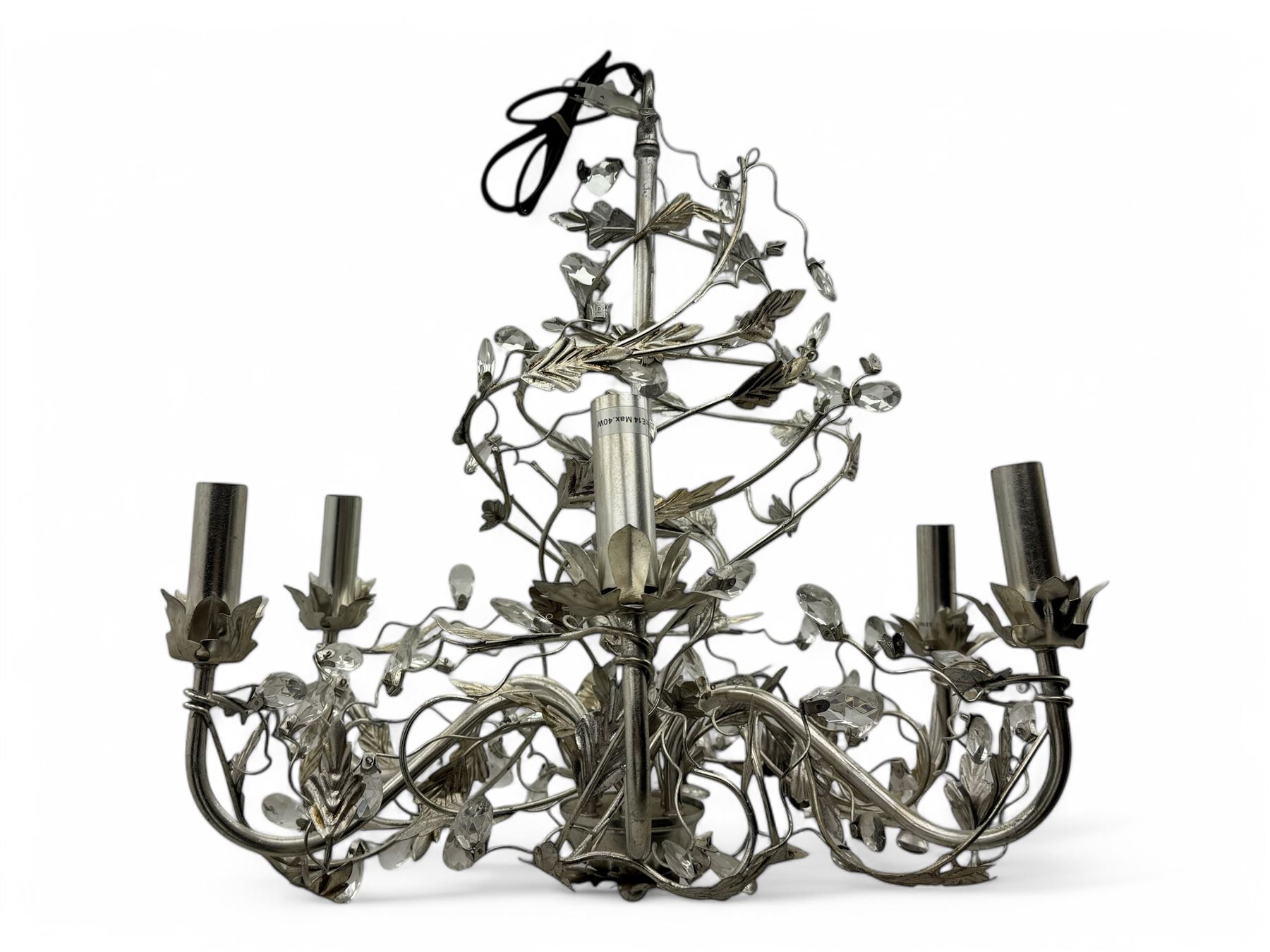 India Jane - silver finish metal chandelier, modelled with scrolling vines and leaves, embellished with faceted glass drops, fitted with six candle sconces, and wired for electricity