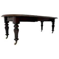 Victorian mahogany extending dining table, circular telescopic extending top with moulded edge, two additional leaves, on turned and lobe carved supports with brass and ceramic castors 