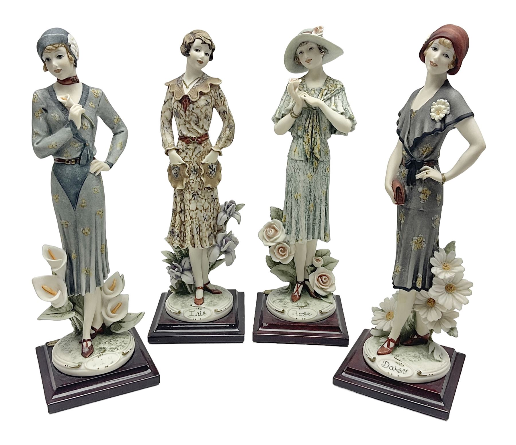 Set of four Giuseppe Armani Florence figures, Iris, Rose, Lily and Daisy, each modelled as ladies in 1920s dress amongst flowers, with names and signature inscribed and upon mahogany base, H23cm