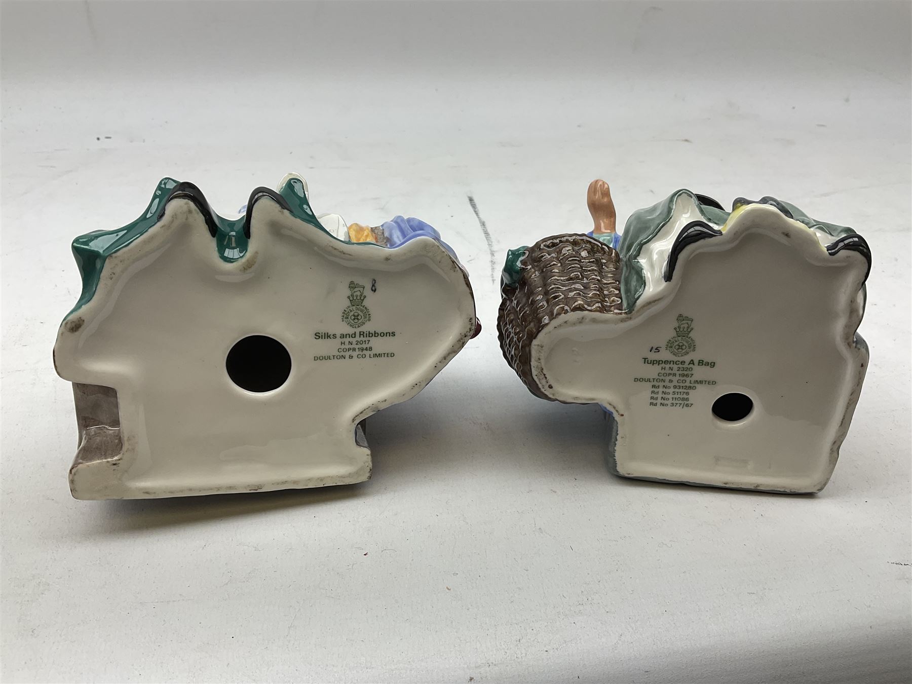 Two Royal Doulton figures comprising 'Tuppence a Bag' HN2320 and 'Silks and Ribbons' HN2017