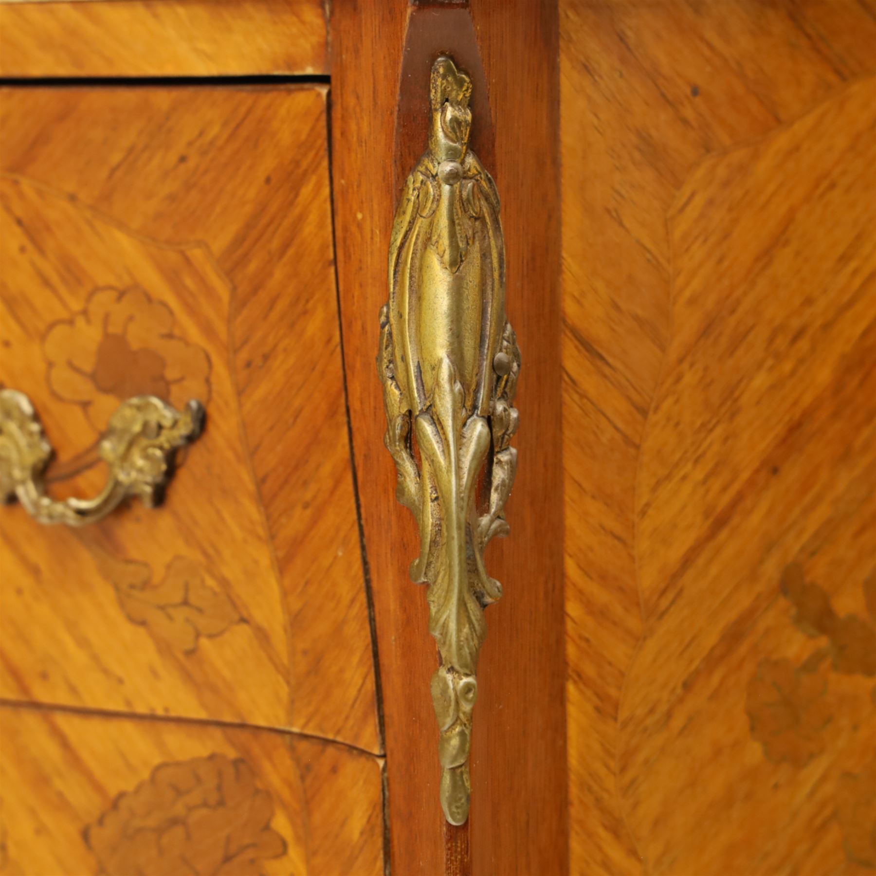 Pair of Louis XV style kingwood and marquetry bedside cabinets, the serpentine sienna marble top above two bombe fronted drawers with rococo style bronze handles and masks on slender cabriole legs terminating in bronze sabots  