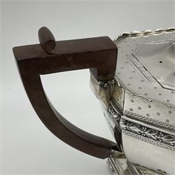 Victorian silver four piece tea service, comprising teapot, teapot stand, twin handled open sucrier and milk jug, each of octagonal form with foliate bud border and engraved decoration including crest to canted panels, and vacant panels, the teapot with ivory finial to the hinged cover and later wooden handle, hallmarked Edward Barnard & Sons Ltd, London1896, teapot including finial H15cm, milk jug including handle H16cm, teapot stand W11.5cm

This item has been registered for sale under Section 10 of the APHA Ivory Act