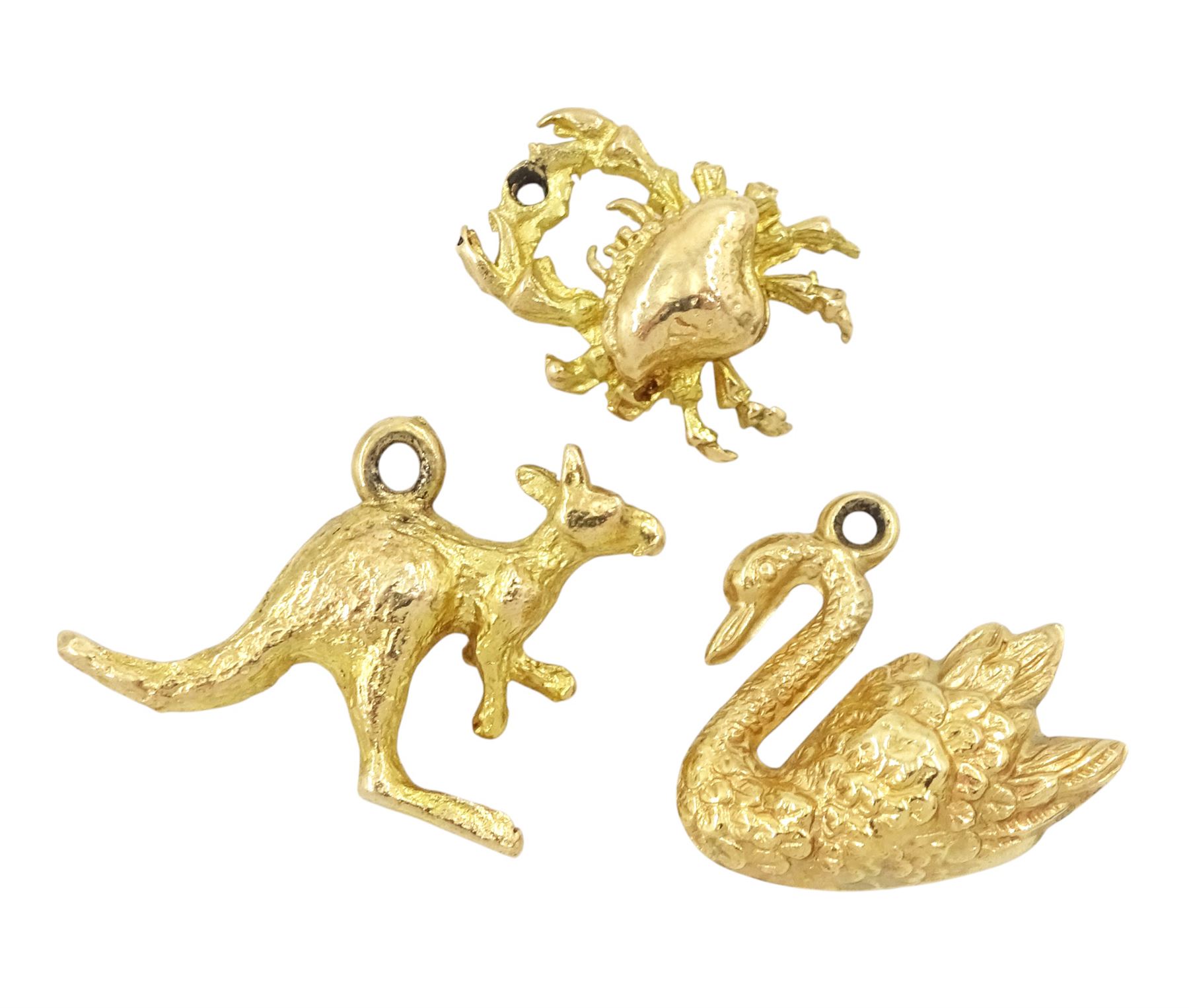 Three 9ct gold pendant / charms including kangaroo, crab and swan