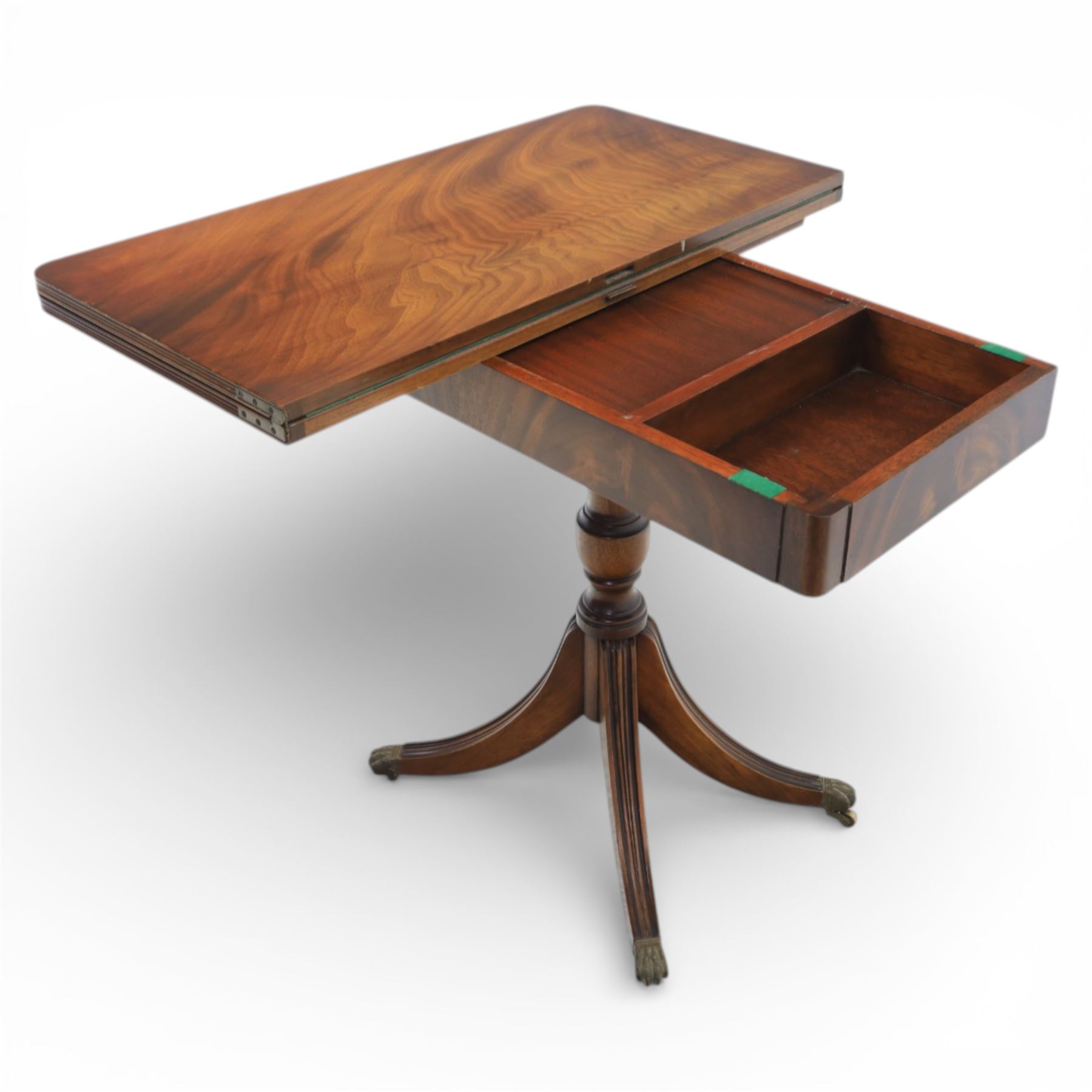 Victorian design mahogany card table, rectangular top with swivel and fold open action, revealing a baized lined interior, raised on turned baluster column, with reeded legs terminating in brass paw castors 