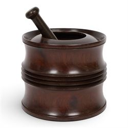 18th century lignum vitae captive mortar and pestle, the mortar of turned waisted form with central reeded girdle, and captive opening with rolled rim, H12.5cm D14cm, and pestle L17.5cm