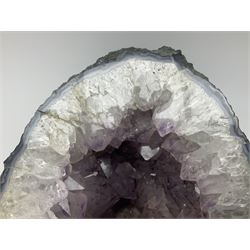Amethyst crystal ‘cathedral’ geode, free standing with flat base and prepared outer surface, with well-defined crystals of various sizes within the cavern, H39, L32cm
