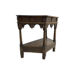 Jacobean design carved oak side or credence table, demi-heptagon top with moulded edge, frieze carved with foliate C-scroll design above ornate arcade carved apron, under-tier united by ring turned pilisters, lower frieze carved with repeating lunettes