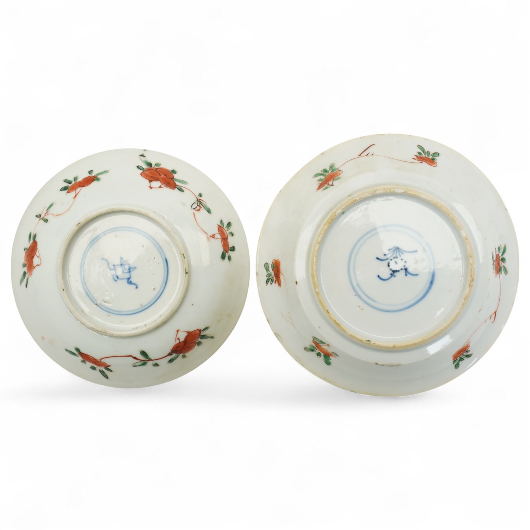 Three Chinese famille verte examples, approximately Yongzheng period, to include two teabowls and two saucers, each decorated with flowers and butterflies, two with sacred fungus mark within double rings, the teabowl with lotus mark, the other indistinct - possibly a Wan mark within lozenge (4)