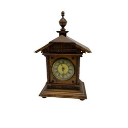 A German musical alarm clock (model 1523/24) made by the Hamburg Amerikanische Uhrenfabrik c1880, in an oak case with an architectural top and finial, two-part dial with a gilt centre, ivorine chapter and steel spade hands, with roman numerals and minute track, case raised on four bun feet, with a thirty-hour balance wheel pin pallet spring driven movement sounding the alarm on a musical movement, key wound and set from the rear. Compete with three different and changeable musical movements in their original box. These clocks would have been sold as here with separate musical movements, it is rare to find them with the original clock.
H30 W17 D11 

	



