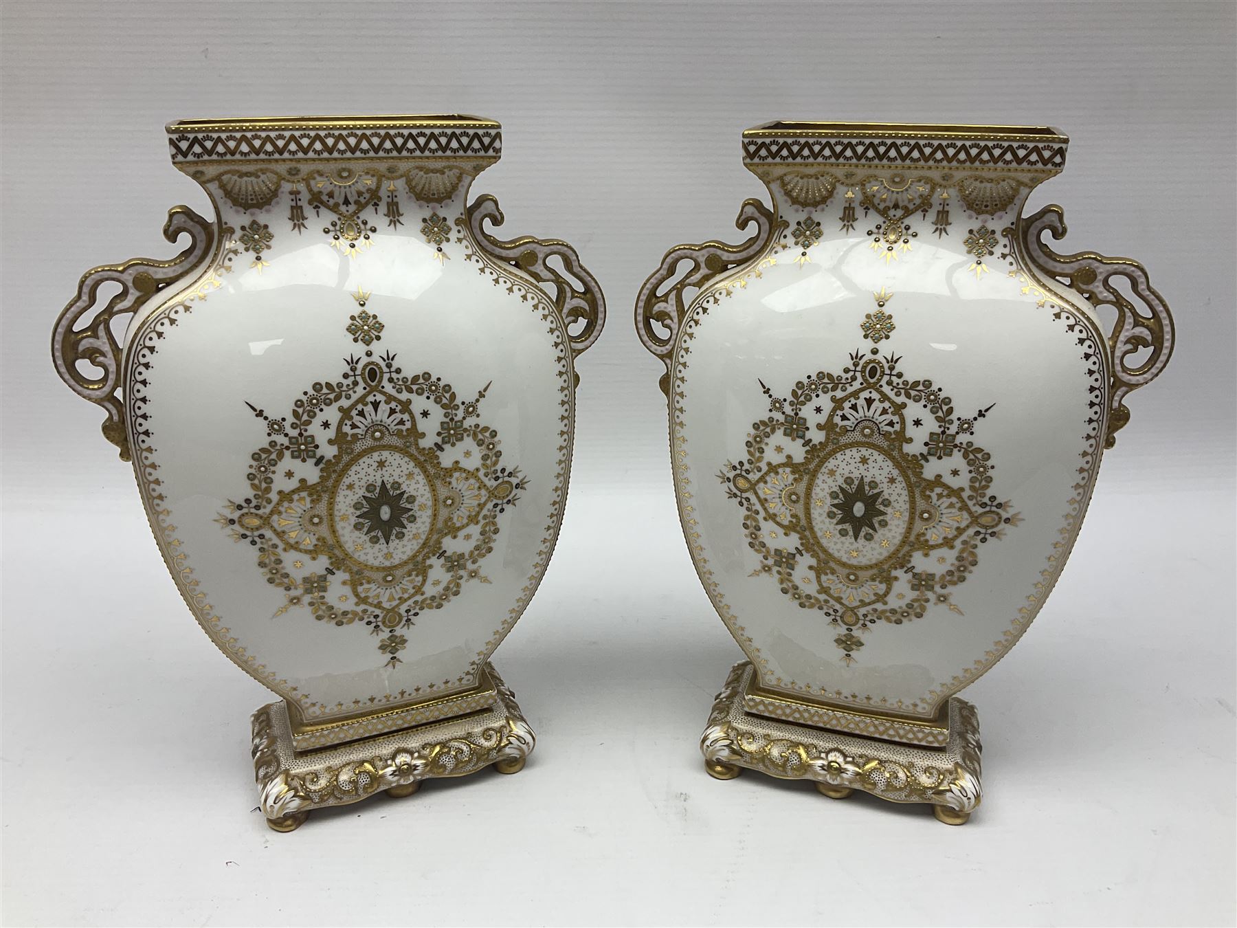 Pair of Copelands enamel jeweled twin handle vases, each decorated with a seated female figures, makers mark beneath, H22cm