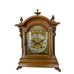 German - 19th century 8-day walnut bracket clock, striking the quarters on two coiled gongs, case with a break-arch top surmounted by cast brass finials, canted corners to the front with cast brass caryatids and sound frets to the sides, brass break arch dial with a silvered chapter ring, steel gothic hands, spandrels, and pendulum regulation dial. With pendulum.