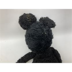 Large soft toy of Mickey Mouse, probably mid-20th century, the black plush body wearing orange shorts, gloves and leather boots, the head with applied painted leather eyes, leather nose and open mouth H68cm