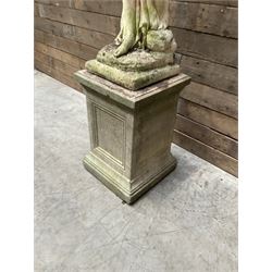 Cast stone garden figure of a bathing lady, raised on square plinth