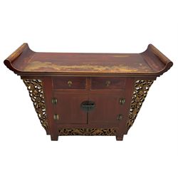 Chinese red lacquered elm side cabinet, fitted with two drawers and two cupboards, shaped and carved sides
