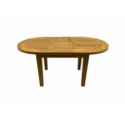 Solid oak oval extending dining table, butterfly leaf extension, four chairs with brown upholstered seats