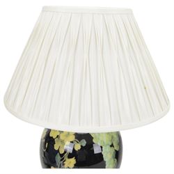 Pair of Jenny Worrall table lamps, of ovoid form, the glass body decorated with fruit and trailing flowers upon a black ground with gilt flecks, with pleated cream lampshades, including shades H65cm
