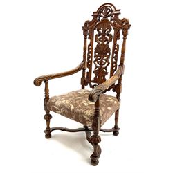 20th century Carolean style carved oak armchair, the back carved with scrolls and foliage, lobe carved supports joined by curved x-frame stretchers