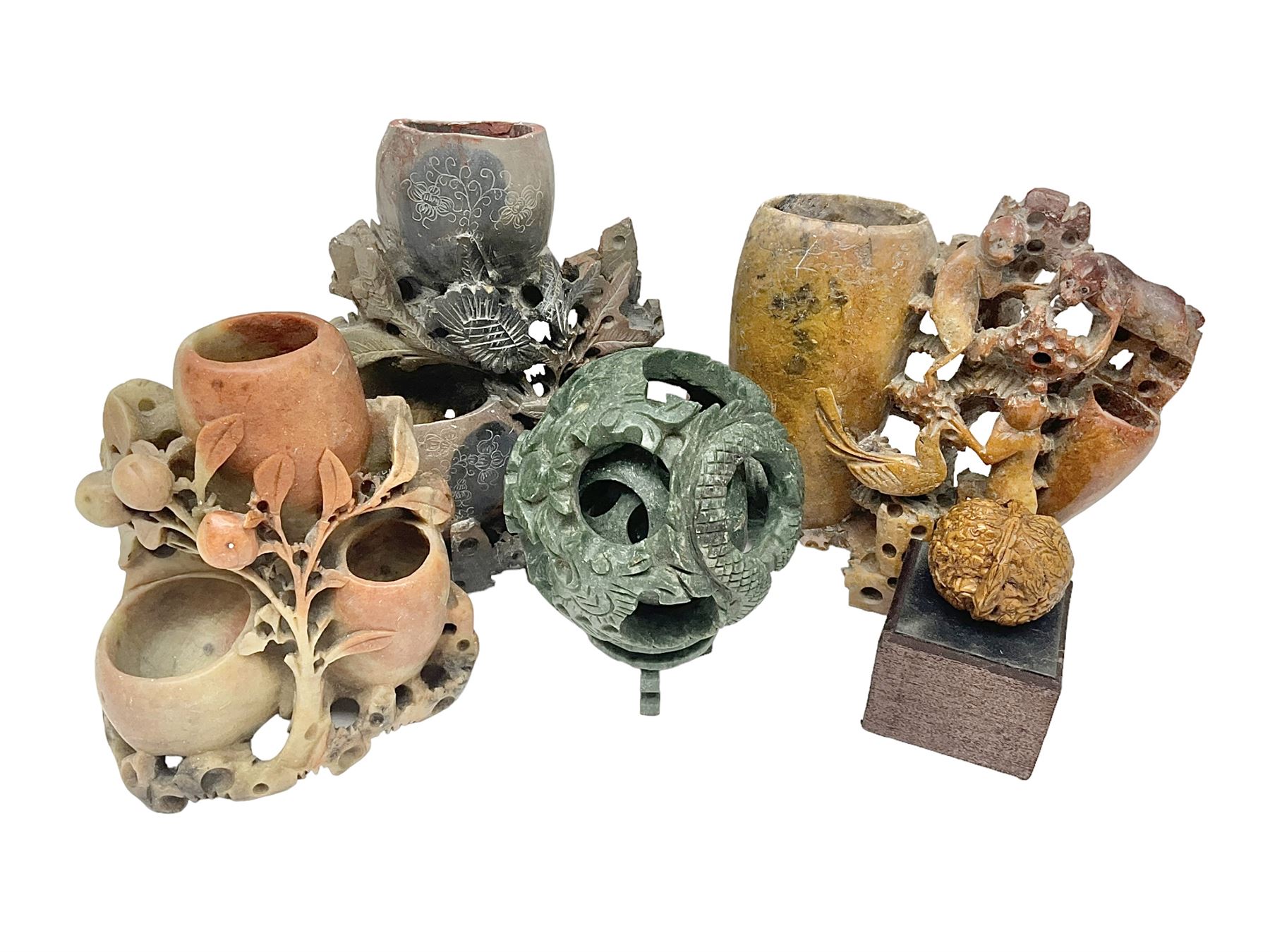 Carved soapstone puzzle ball, together with carved walnut shell and three soapstone brush pots, ball D12cm