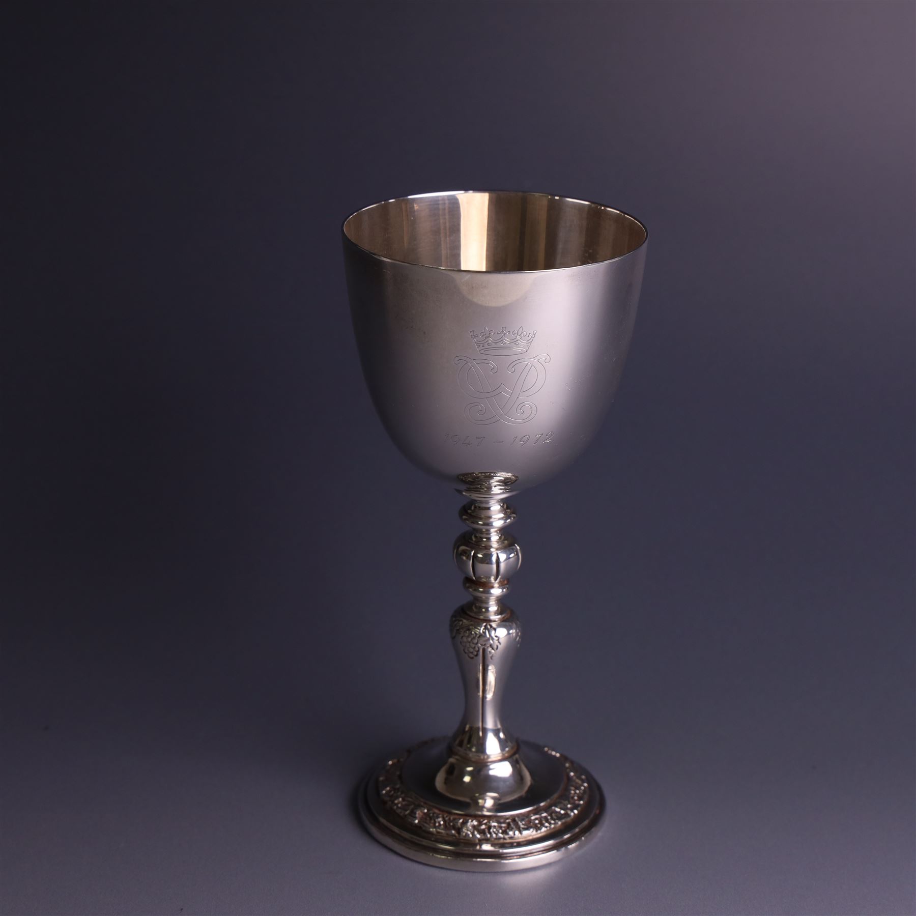 Late 20th century limited edition silver goblet, produced by Garrard & Co Ltd  to commemorate the silver wedding anniversary of Her Majesty Queen Elizabeth II and His Royal Highness the Duke of Edinburgh, the bowl engraved with Royal cyphers and anniversary dates, upon a knopped stem and embossed foot, no. 77/2000, hallmarked Garrard & Co Ltd, London 1972, H15cm