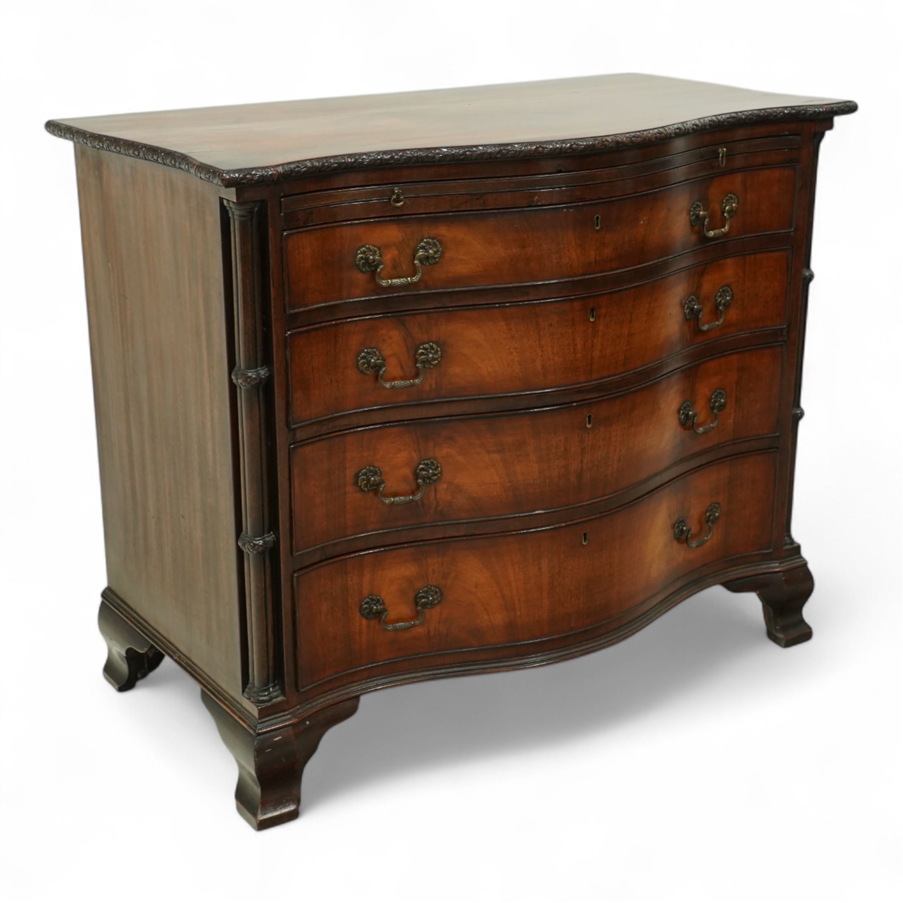 Georgian design mahogany serpentine chest, with rectangular top with floral rosette carved edge, cluster reeded columns with brush slide above four graduated drawers on ogee bracket feet 