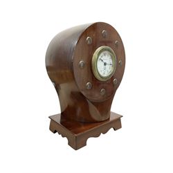 1920's-Aviation clock, mahogany case configured from part of an early 20th century aeroplane propellor, mounted on a conforming plinth with a shaped base, bolt holes filled with brass studs and fitted with an 8-day American spring driven Ansonia insertion movement with a porcelain dial, Arabic numerals, spade hands and seconds dial. Wound and set from the rear.