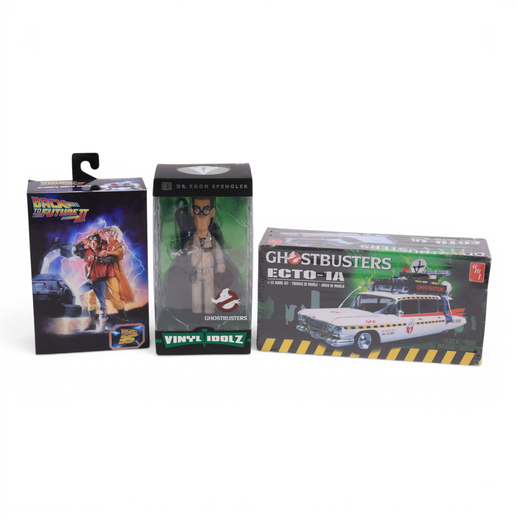 Neca Back to the Future Marty Mcfly figure, AMT Ghostbusters Ecto-1A 1:25 scale model kit and Vinyl Idolz Egon Spengler figure, all boxed