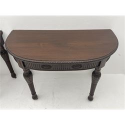 Pair early 20th century Hepplewhite style mahogany D-end console tables, the curved top with foliate carved edge, fluted frieze rails carved with flower heads, turned and reeded acanthus supports with recessed castors
