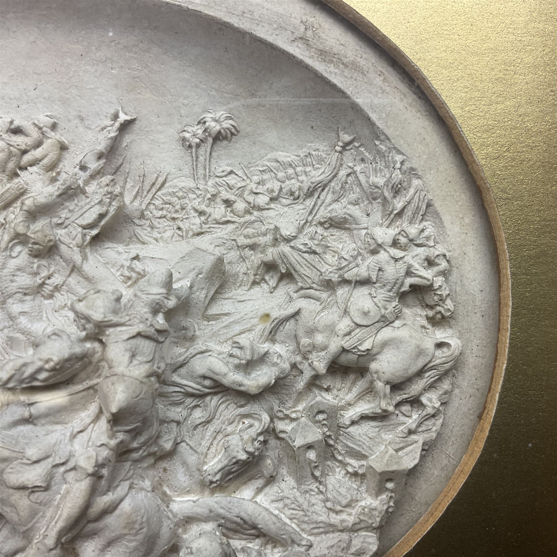 Justin Mathieu, two oval high relief plaque depicting a battle scenes, each within a wooden frame, frame  H21cm, L25cm