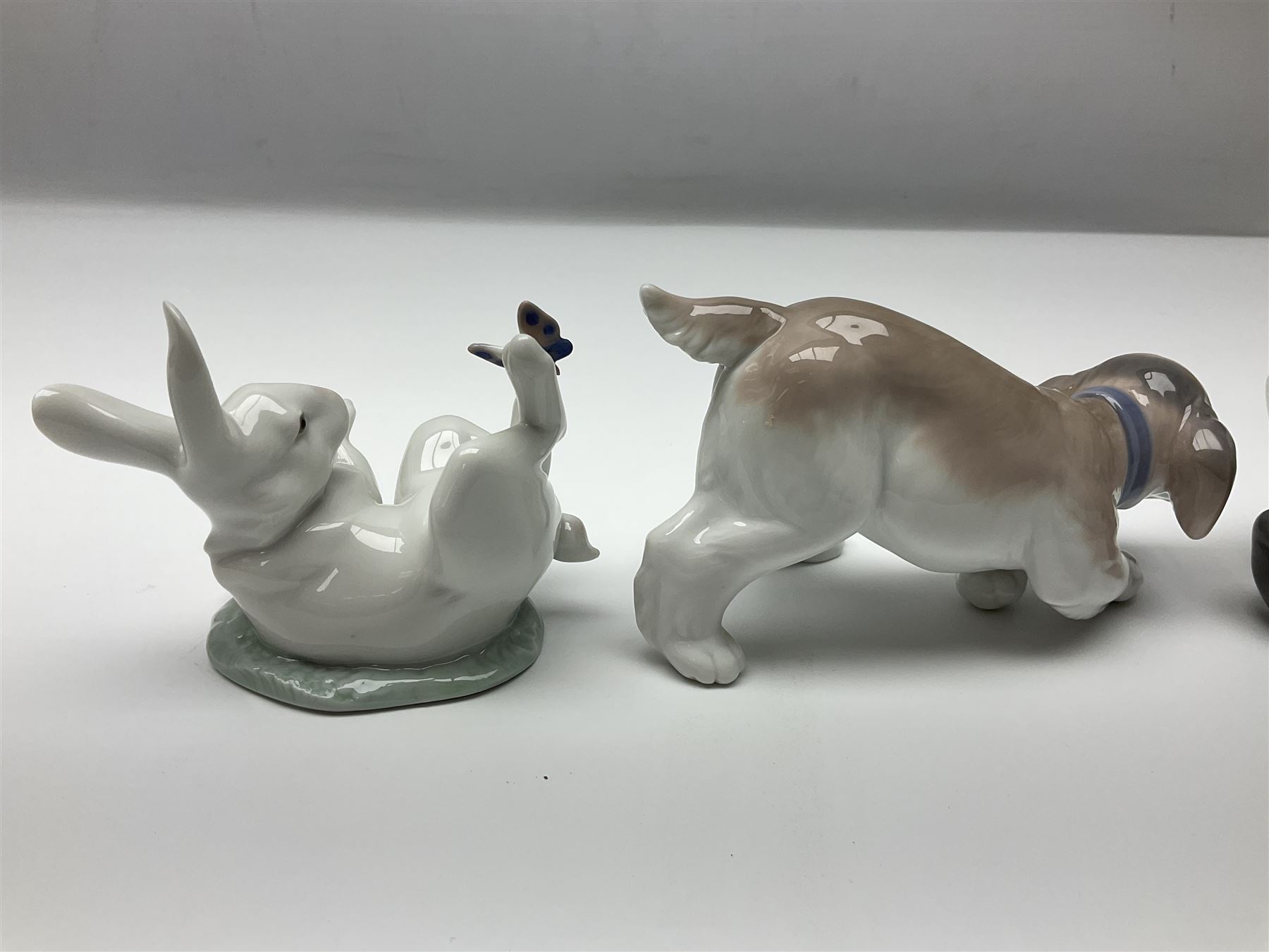 Five Lladro figures, comprising Cat and Mouse no. 5236, That Tickles no. 5888, Gentle Surprise no. 6210, Little Hunter no. 6212 and Resting Polar Bear no. 1208, largest H12cm