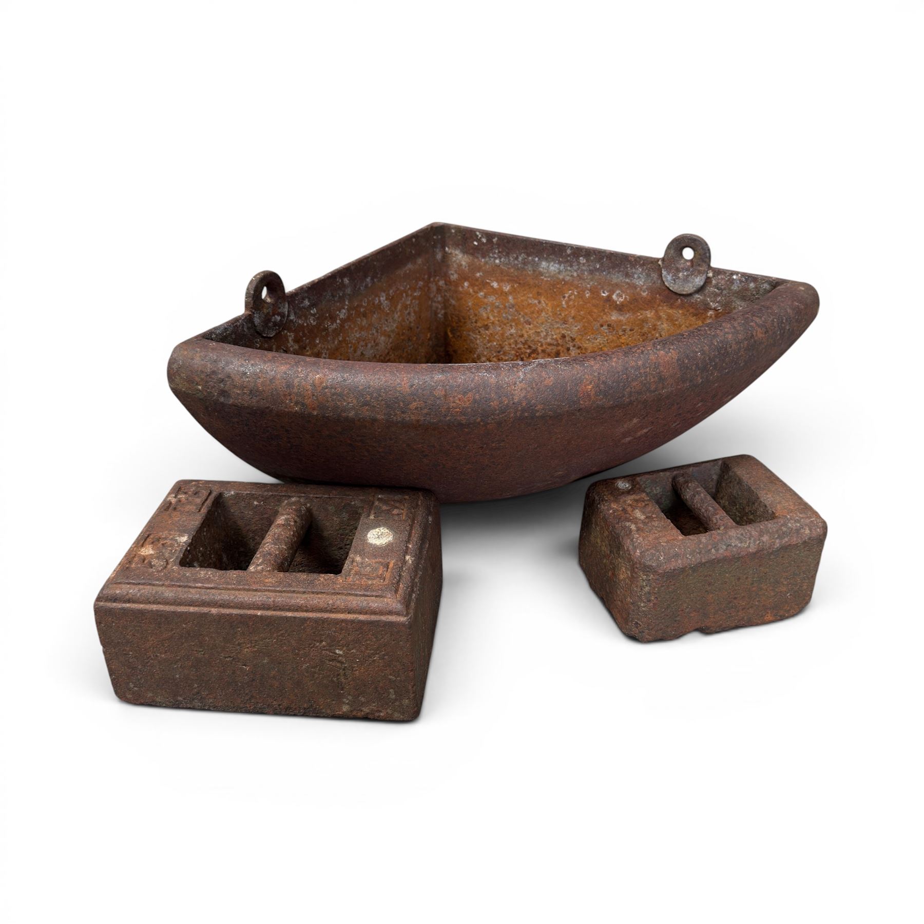  Cast iron corner manger along with one 56lb cast iron weight and another of unknown weight