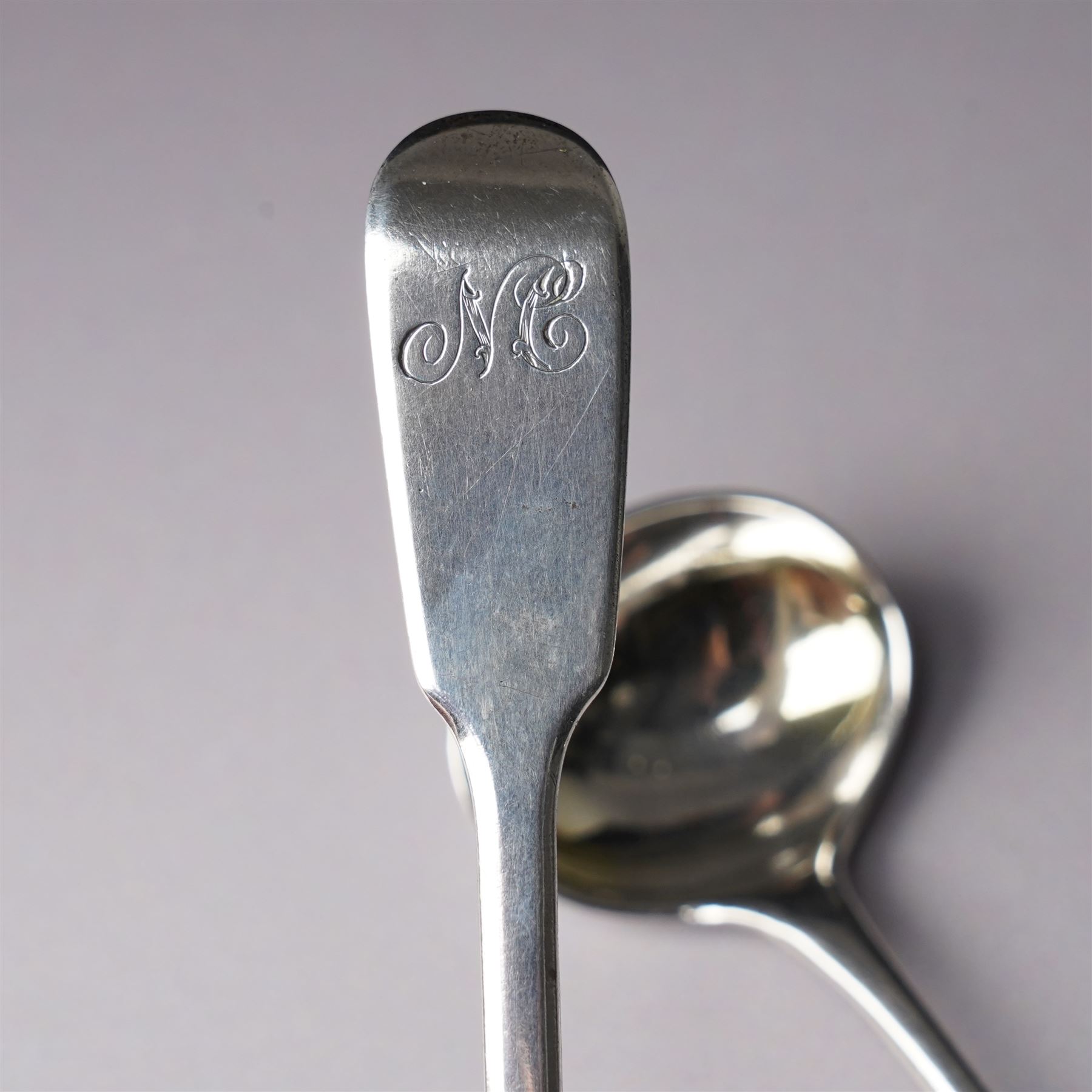Pair of George III silver circular salts with gilded interiors and embossed decoration and two 19th century condiment spoons, one by Peter and Ann Bateman 