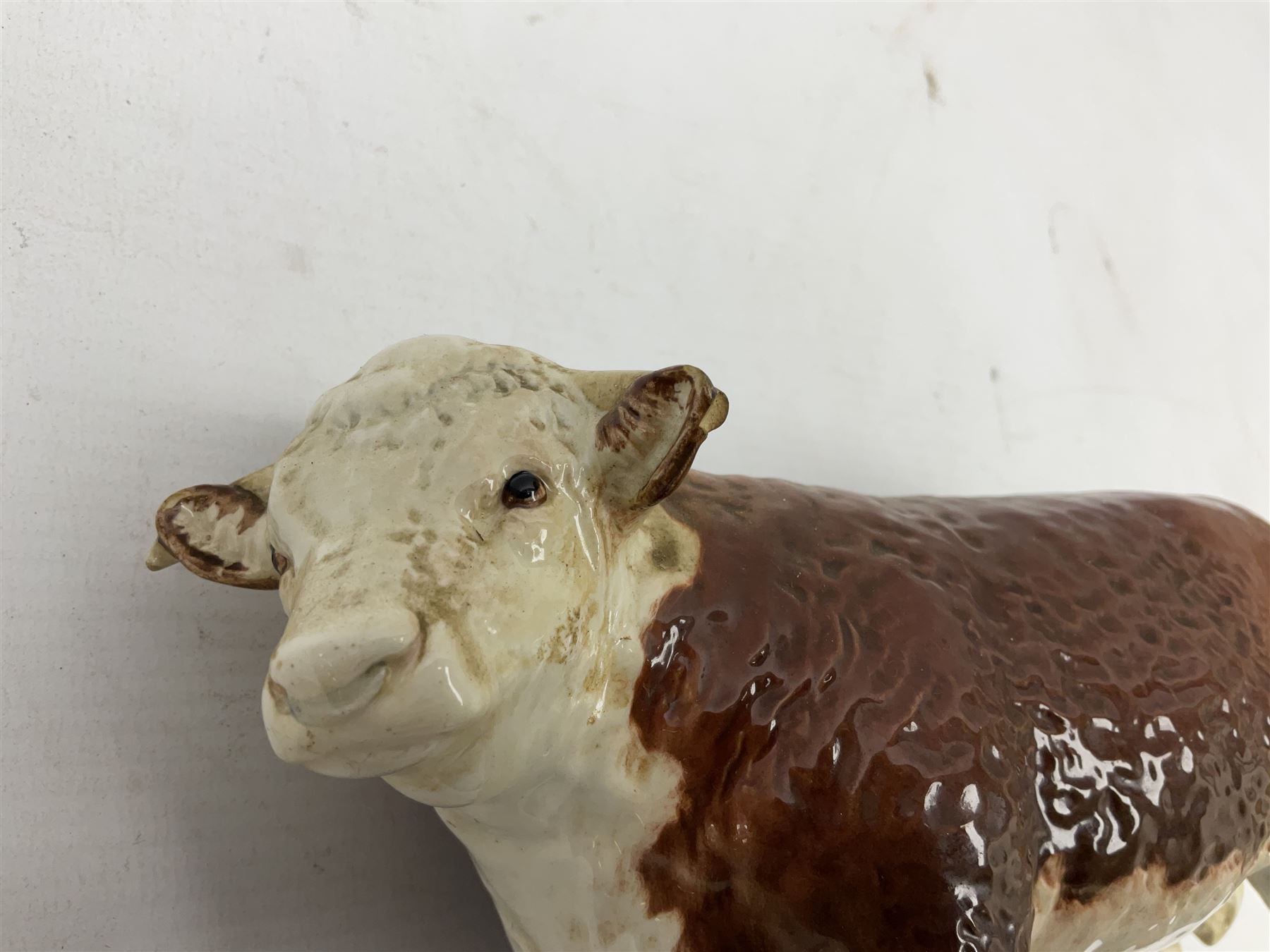 Five Beswick cows, comprising Aberdeen Angus cow, approved by the Aberdeen Angus Cattle Society no. 1562, Two Hereford Bulls, 'Ch. of Champions' no. 1363, Hereford  cow 'Ch of Champion' no. 1360, and calf no.1827, all with printed mark beneath 