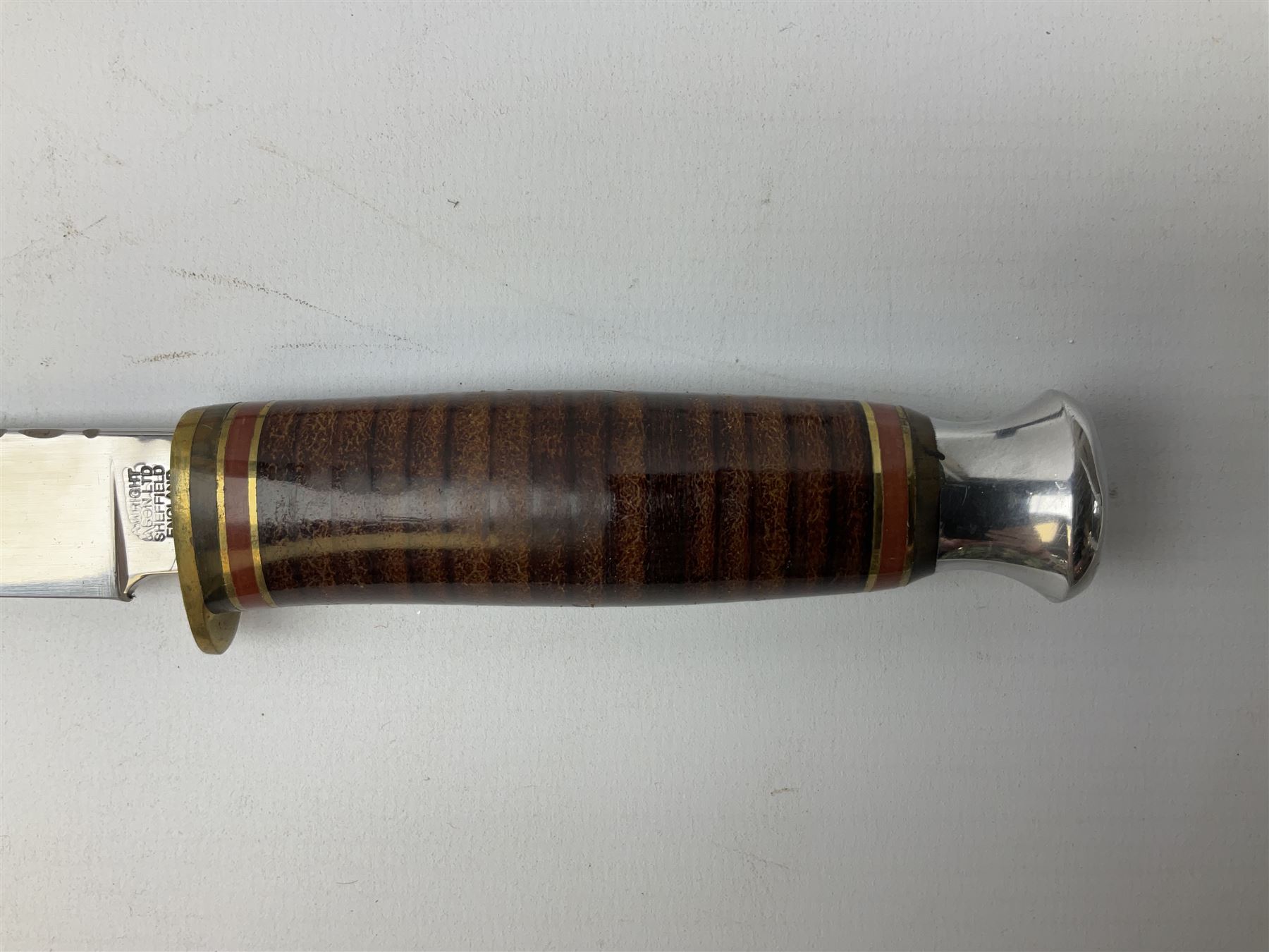 Three hunting knives, each blade marked A. Wright & Sons Sheffield, one with leather handle, one with horn handle and one with antler handle; each with leather sheath (3)