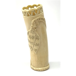 An African carved ivory spill vase, of cylindrical form with pierced rim and gadrooned band to base, the body decorated with snake and insect, signed to interior, H14cm.