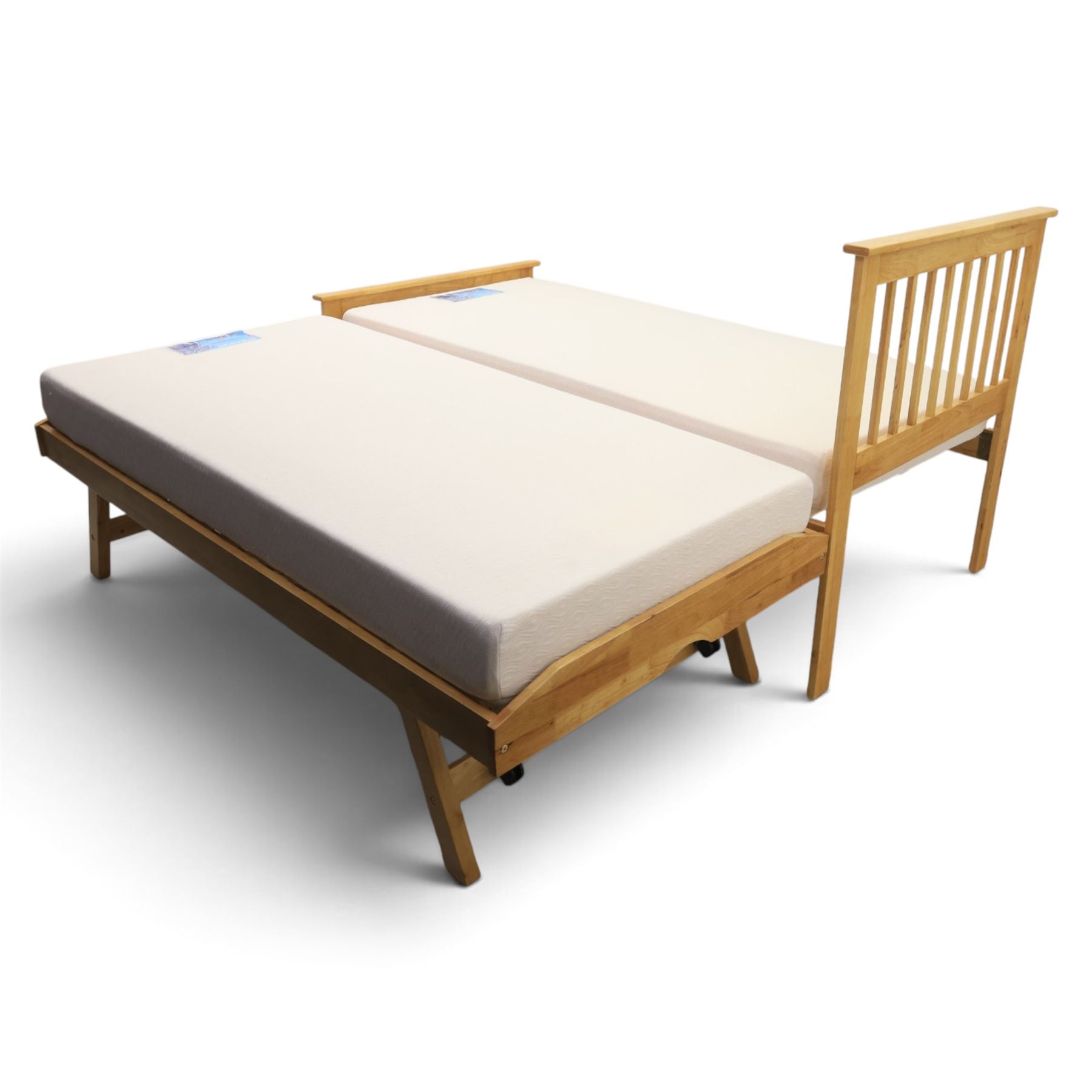Contemporary light oak trundle bed, slatted headboard and footboard,  incorporating pull-out trundle bed on castors, complete with two memory foam mattresses