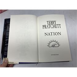 Collection of twenty-three hardback Terry Pratchett books, comprising approximately eighteen first editions including The Fifth Elephant signed & inscribed by Pratchett, all with dustjackets