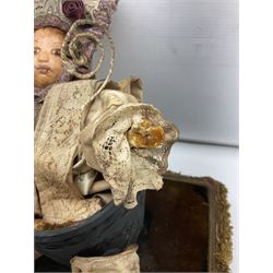 Modern reproduction automaton in the form of a baby doll in a basket clothed in Victorian style lace bloomers and frilled bonnet; clockwork action; on raised platform; with French paper label on base, 29cm wide,