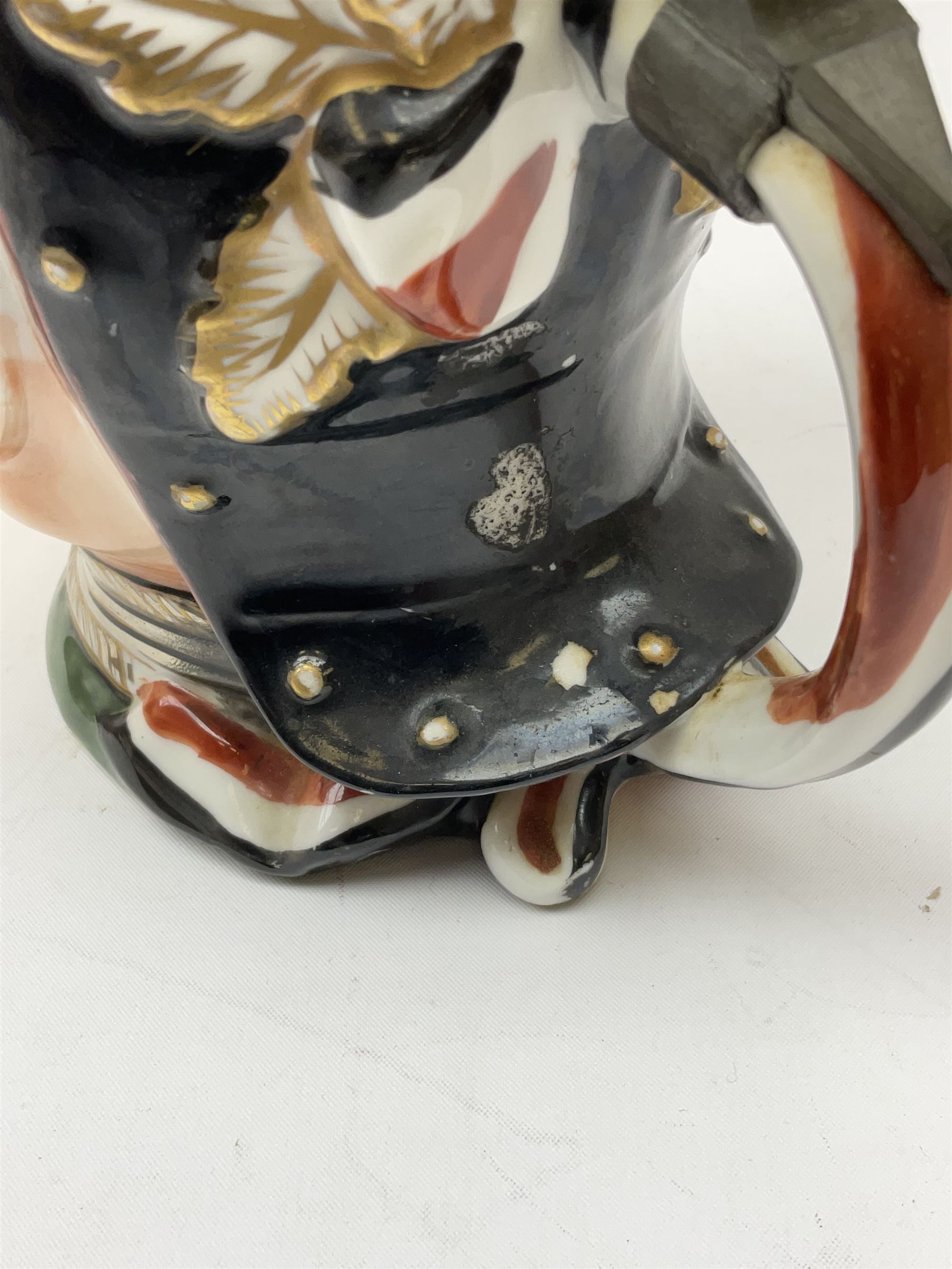 Otto Von Bismarck figural 0.5l stein, his black pickelhaube helmet with chrome spike serving as the lid, in green uniform and gilt detail throughout, pewter thumb hinge, with blue hash Musterschutz type mark, H18cm