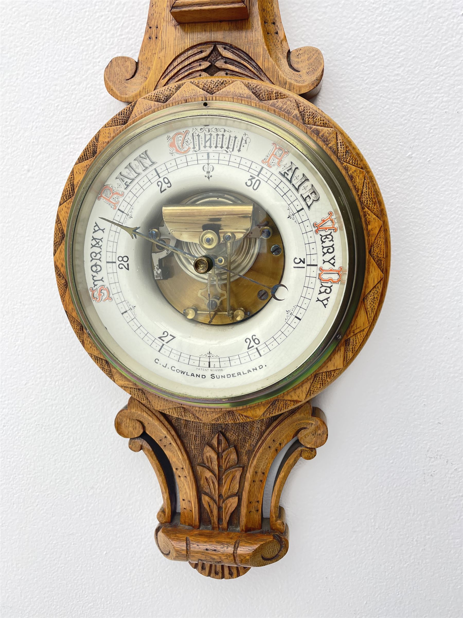 Early 20th century carved oak card aneroid barometer with visible aneroid and mercury thermometer, by ‘C. J. Gowland, Sunderland’ 