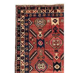 Near pair of Persian Azerbaijan red ground runners, each rug decorated with Nazarlik and stylised leaf motifs, enclosed with three band border decorated with flower heads and geometric motifs 

406cm x 99cm 
409cm x 102cm
