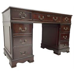 Georgian design mahogany twin pedestal desk, the top with inset red oxblood leather writing surface, fitted with nine cock-beaded and graduating drawers