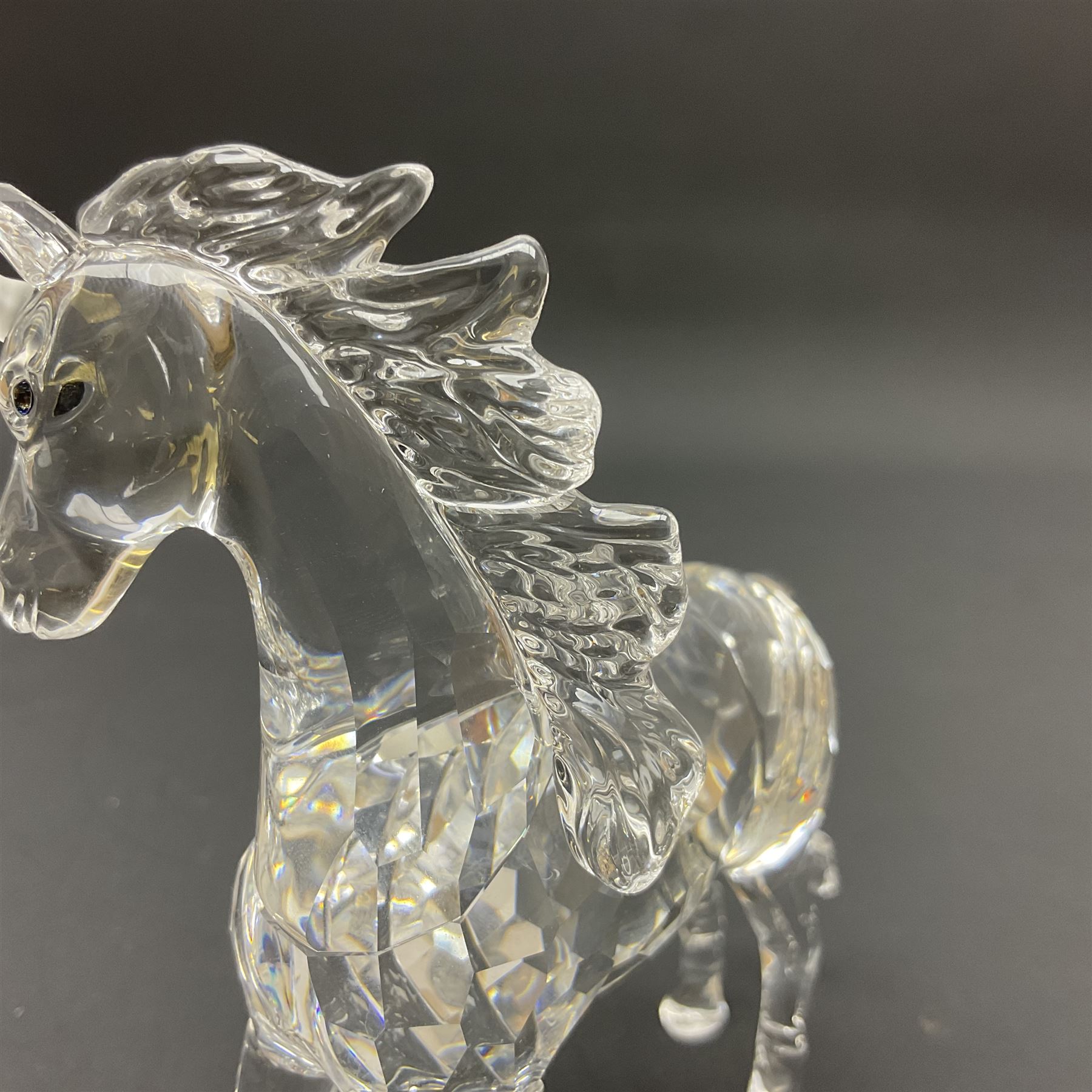 Swarovski Crystal animals, comprising white peacock, the tail with cascading blue flowers, perched eagle with yellow beak, ibex with frosted crystal horns and unicorn with frosted crystal horn, tallest H13cm
