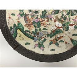 Near pair of late 19th/early 20th century Chinese Famille Verte crackle glaze chargers, decorated with mountainous landscapes containing warriors on horseback and foot, within simulated bronze incised borders, largest D40cm