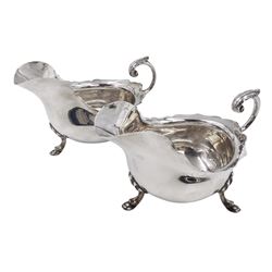 Pair of silver sauce boats, of typical plain form, with acanthus capped flying scroll handle and each upon three hoof feet, hallmarked Walker & Hall, Birmingham 1901, H9cm