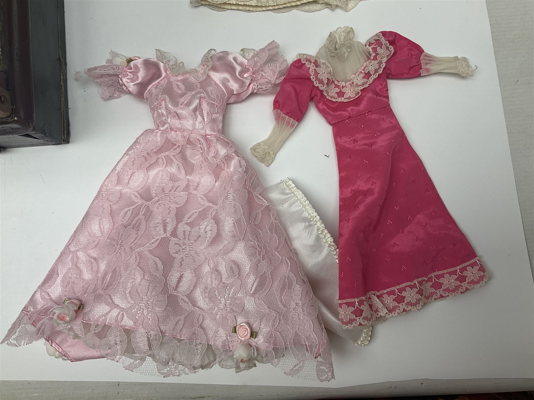 Early 20th century scratch-built wooden hat & gown shop diorama 'Joan', of double-fronted form glazed on three sides with brass and aluminium mounts, rear access apertures and storage under L63cm H45cm D31cm; with small collection of dresses and hats on display stands