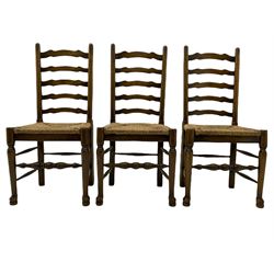 Set of six 18th century style oak dining chairs with waved ladder backs and drop in rush seats