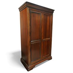 Willis & Gambier - French cherry wood double wardrobe, moulded cornice above two panelled doors opening to a hanging interior with rail and shelf, raised on bracket feet
