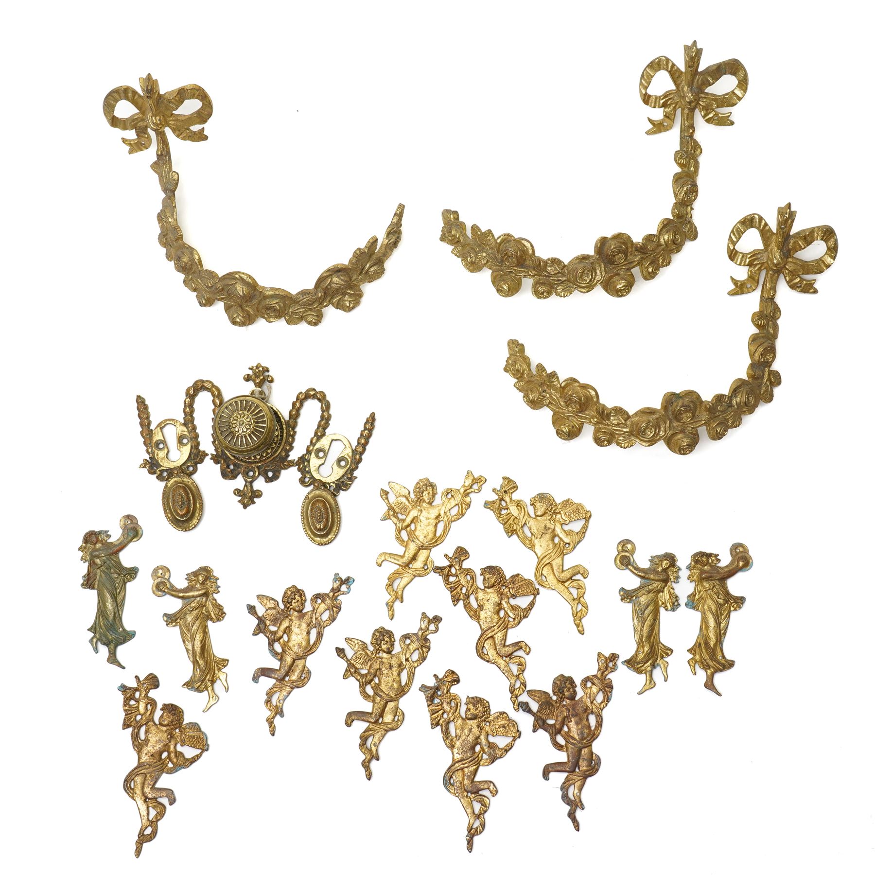 Victorian brass double key door plate by Thomas Elsley, possibly for a safe, three brass curtain tie backs formed as garlands, four brass cherub door plates marked 'H.V.' , four others similar and four others of female figures playing cymbals 
Provenance: property of a Nobleman