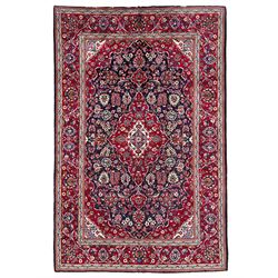 Persian indigo ground rug, the central crimson pole lozenge medallion surrounded by interlacing floral patterns, the main border with repeating plant motifs connected by scrolling branches